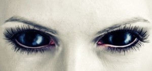 32723010 - evil black female alien, vampire or zombie eyes. dirt make up. macro. halloween theme